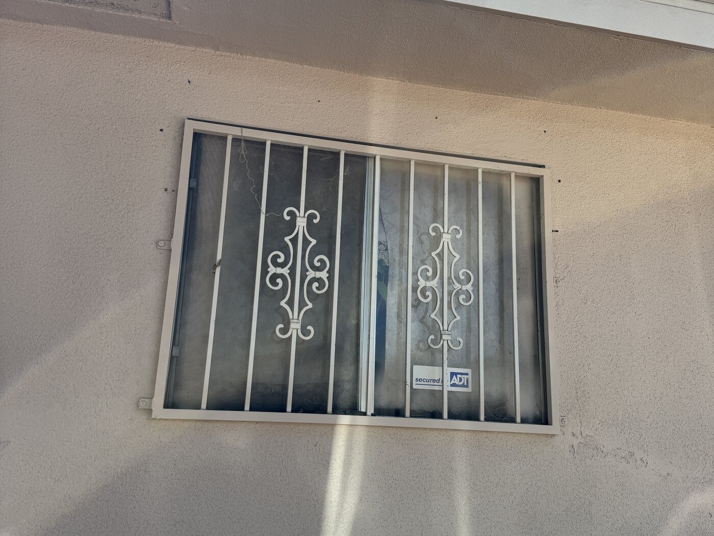 Old louvered aluminum windows on a Fresno, CA home before replacement